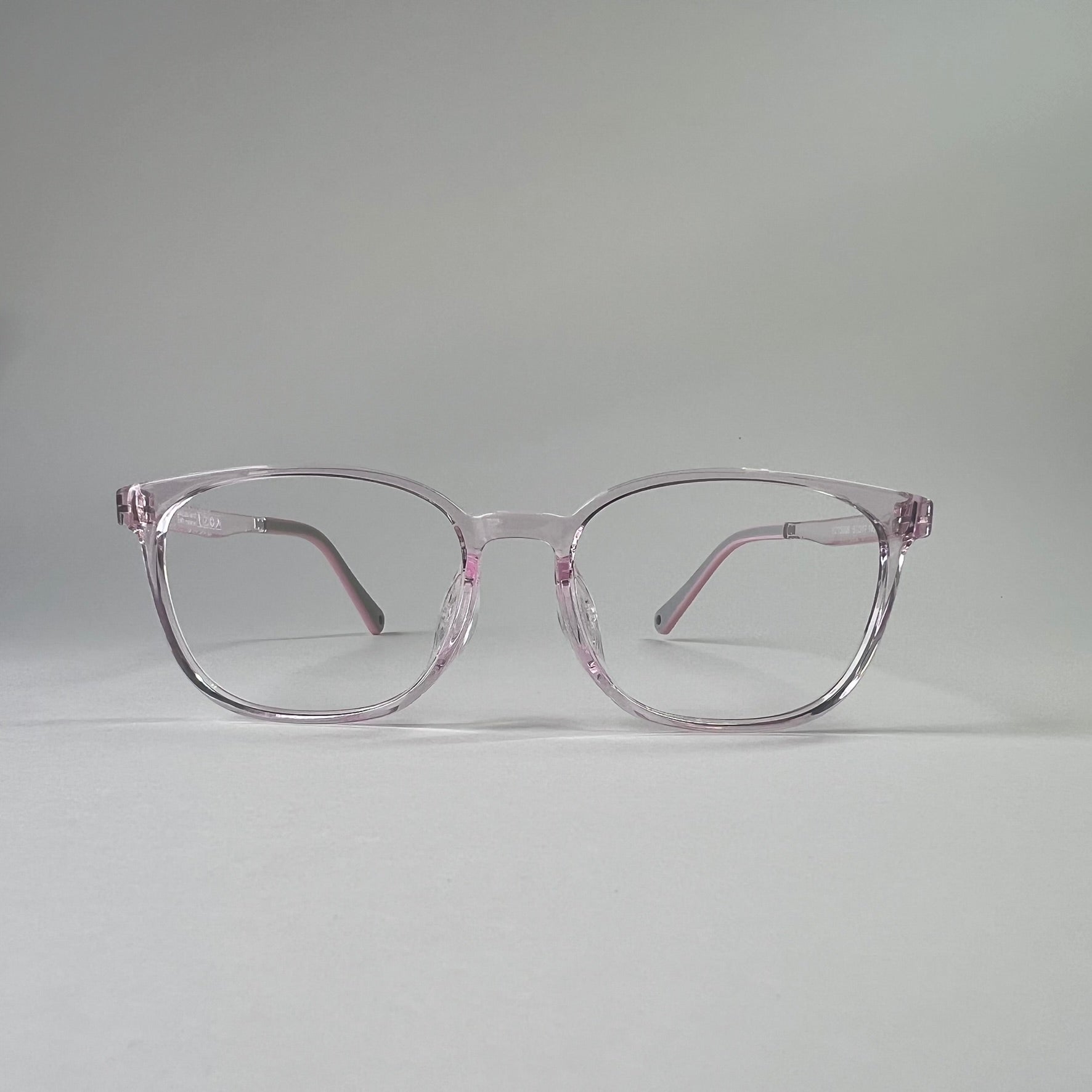 MiniMuse clear jelly pink rounded square prescription glasses for kids and tweens with silicone nose pads and adjustable temple tips. Front view.
